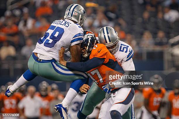 Denver Broncos quarterback Brock Osweiler is sandwiched between Dallas Cowboys linebacker Kyle Wilber and linebacker Anthony Hitchens during the...