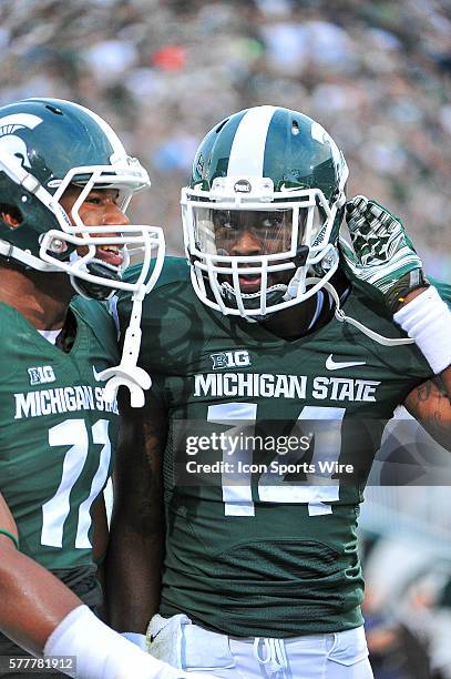 Michigan State Spartans quarterback Colar Kuhns congratulates Michigan State Spartans wide receiver Tony Lippett on his long touchdown reception in...