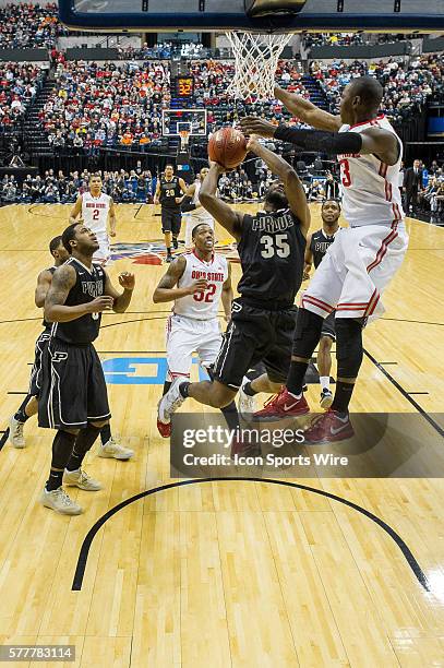 Ohio State Buckeyes guard Shannon Scott blocks the shot of Purdue Boilermakers guard Rapheal Davis during the Big Ten Men's Basketball Tournament...