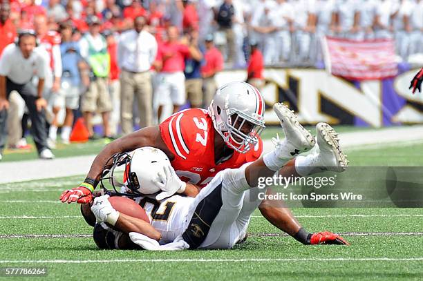 Ohio State Buckeyes linebacker Joshua Perry brings down Navy Midshipmen wide receiver Ryan Williams-Jenkins as he looses his helmet at M&T Bank...