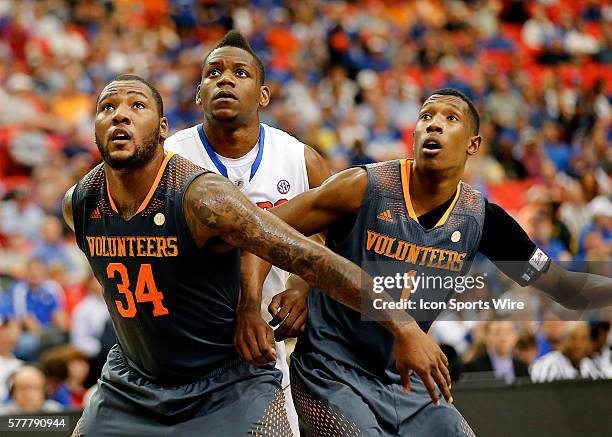 Jeronne Maymon and Josh Richardson of Tennessee and Will Yeguete of Florida watch the free throw during the SEC Basketball Tournament semi-final...