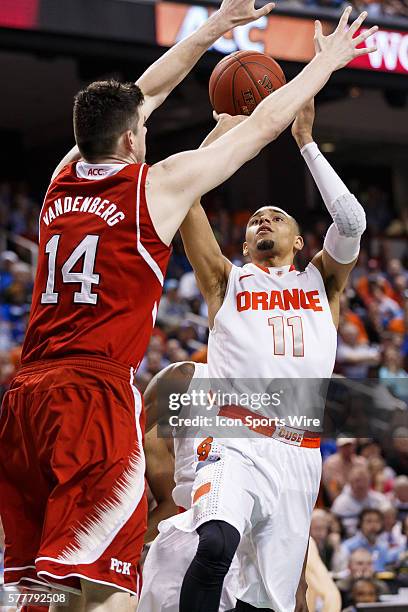 Syracuse Orange guard Tyler Ennis shoots the ball in front of North Carolina State Wolfpack center Jordan Vandenberg during the ACC 2014 basketball...