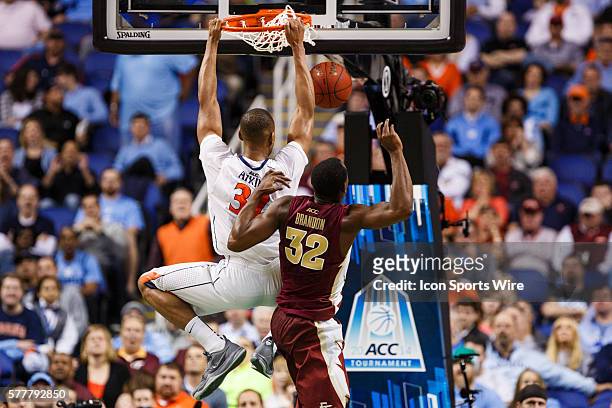 Virginia Cavaliers forward Darion Atkins dunks the ball past Florida State Seminoles guard Montay Brandon during the ACC 2014 basketball tournament...