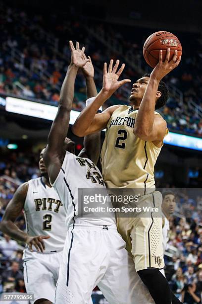 Wake Forest Demon Deacons forward Devin Thomas shoots the ball over Pittsburgh Panthers forward Talib Zanna during the ACC 2014 basketball tournament...