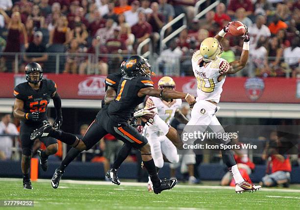 Florida State Seminoles wide receiver Rashad Greene catches the football past Oklahoma State Cowboys cornerback Kevin Peterson during the football...