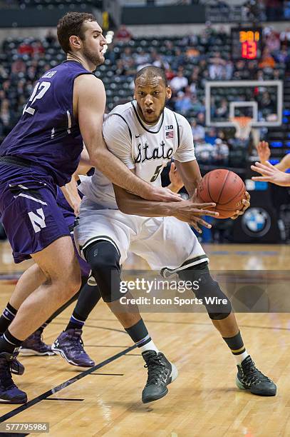 Michigan State Spartans forward Adreian Payne goes by Northwestern Wildcats center Alex Olah during the Big Ten Men's Basketball Tournament game...