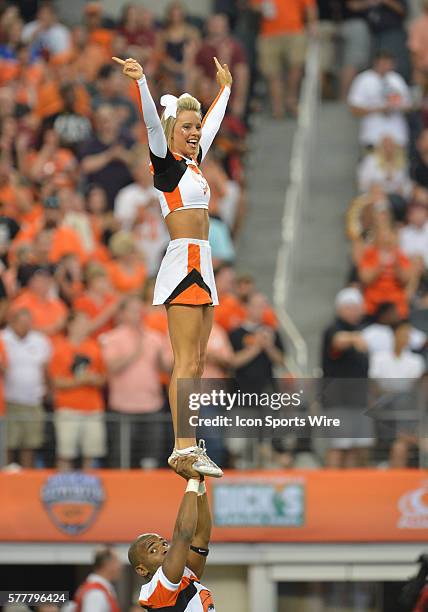 Oklahoma State Cowboys cheerleader performing on the field during the Cowboys Classic - Florida State at Oklahoma State at AT&T Stadium in Arlington,...