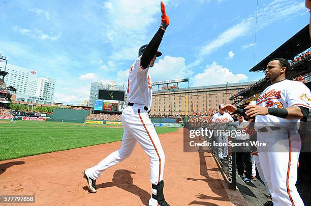 Baltimore Orioles third baseman Ryan Flaherty is congratulated by designated hitter Nelson Cruz after his 3-run home run against the Minnesota Twins...