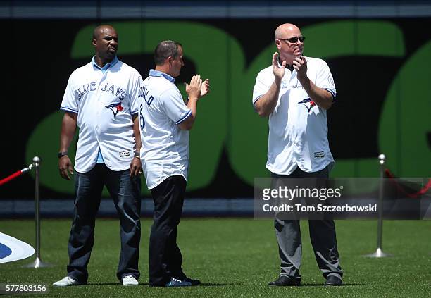 Former players Devon White and John McDonald and Ed Sprague during the franchise"u2019s fortieth anniversary celebrations before the start of MLB...