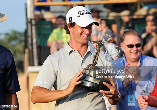 Adam Scott, of Queensland, Australia, holds the championship trophy after the final round of the Valero Texas Open at the TPC San Antonio in San...