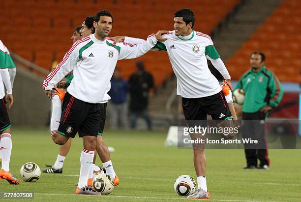 Mexico captain Rafa Marquez stretches with fellow defender Francisco Rodriguez . The Mexico National Team held a light practice at Soccer City...