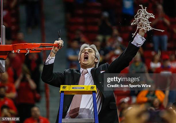 New Mexico Lobos head coach Craig Neal holds up the net to celebrate after the New Mexico Lobos defeated the San Diego State Aztecs 64-58 Final of...