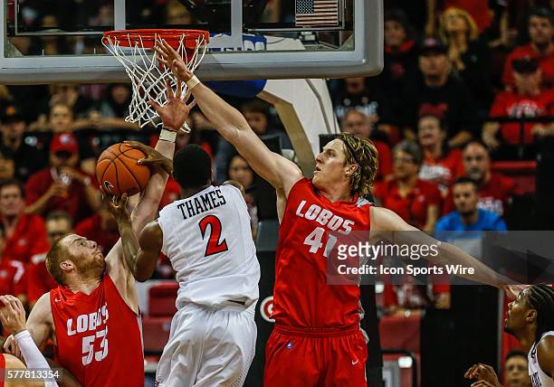 San Diego State Aztecs guard Xavier Thames goes to the basket for a shot while battling the defense of New Mexico Lobos center Alex Kirk and New...