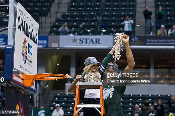 Michigan State Spartans center Adreian Payne holds up the net after winning the Big Ten Men's Basketball Tournament Championship Game game between...
