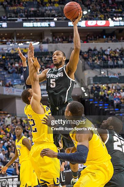 Michigan State Spartans forward Adreian Payne shoots over Michigan Wolverines forward Jordan Morgan during the Big Ten Men's Basketball Tournament...