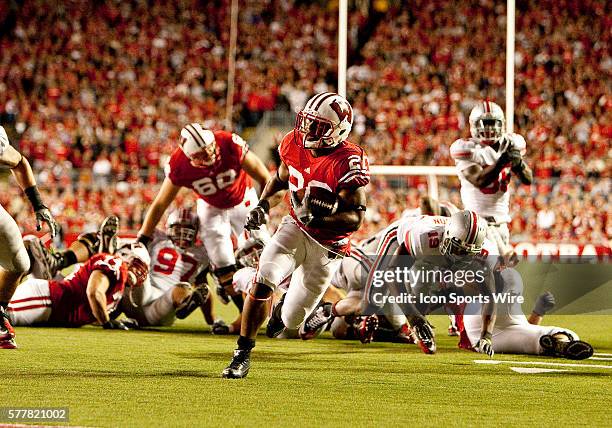 Wisconsin Badgers running back James White brings the ball upfield for a Badgers touchdown. The Wisconsin Badgers won over the Ohio State Buckeyes...