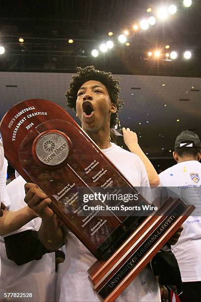 Louisiana Lafayette Ragin Cajuns guard Elfrid Payton holds the Championship Trophy after the University of Louisiana Lafayette Ragin' Cajuns men's...