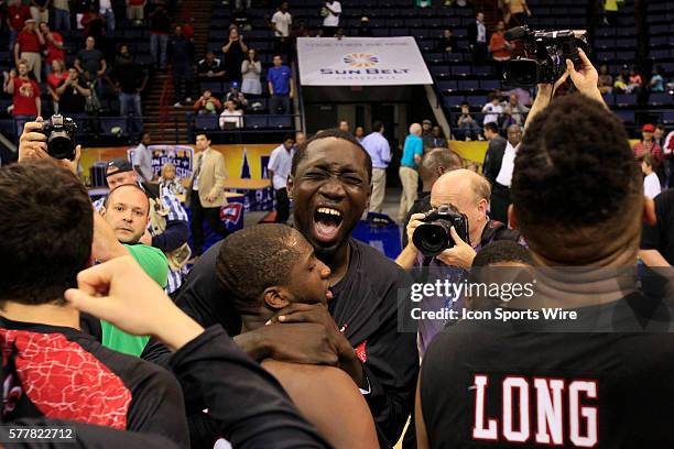 Players celebrate after defeating the Panthers of Georgia State by a score of 82-81 in the Georgia State v University of Louisiana Lafayette Men's...