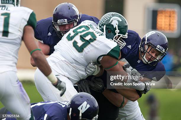 Michigan St. Defensive tackle Jerel Worthy wraps up Northwestern's Mike Trumpy in the first half of their game at Ryan Field, Evanston, Illinois.