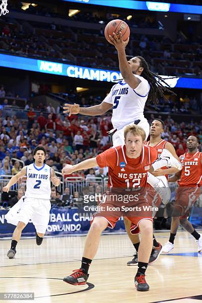 Jordair Jett of the Saint Louis Billikens goes over G Tyler Lewis of the NC State Wolfpack for the shot during the NC State Wolfpack game versus the...