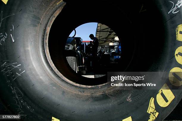 One of Antron Brown's crew members is seen through a racing slick during the finals of the 2010 NHRA Las Vegas Nationals Sunday, October 31, 2010 at...