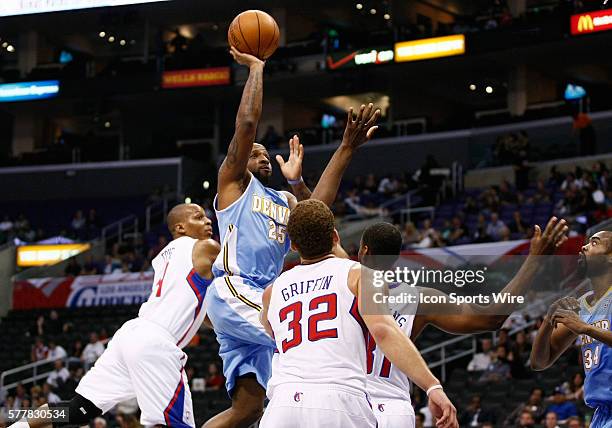 Los Angeles, CA Denver Nuggets point guard Anthony Carter shoots the ball over Los Angeles Clippers center Jarron Collins as the Los Angeles Clippers...