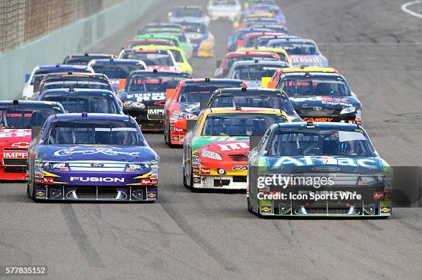 Carl Edwards driving the number 99 Aflac Ford leads Kyle Busch driving the number 18 M&M's / Interstate Toyota , Matt Kenseth driving the number 17...