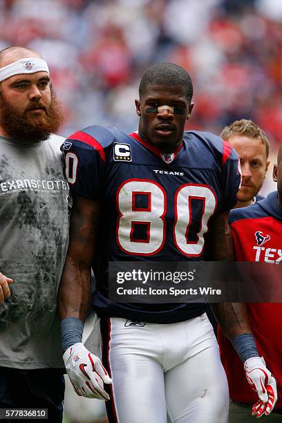 Houston Texans wide receiver Andre Johnson is escorted form the field after being ejected for fighting with Tennessee Titans cornerback Cortland...