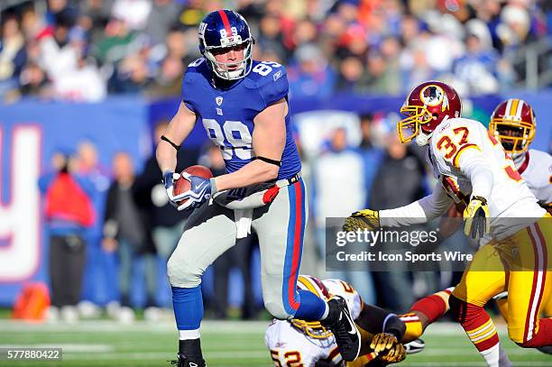New York Giants tight end Kevin Boss carries the ball as Washington Redskins safety Reed Doughty defends during the first half of the game at the New...
