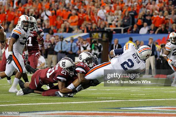 Auburn Tigers quarterback Cameron Newton is tackled by South Carolina Gamecocks linebacker Tony Straughter and South Carolina Gamecocks safety...