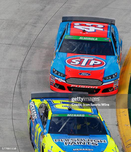 Aric Almirola Richard Petty Motorsports Ford Fusion pressures Paul Menard Richard Childress Racing Chevrolet Impala SS during the STP 500 NASCAR race...