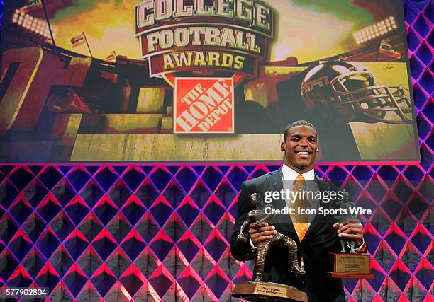 Auburn's Cam Newton holds the Davey O'Brien Award and the Maxwell Award during the Home Depot College Football Awards Show at the Atlantic Dance Hall...