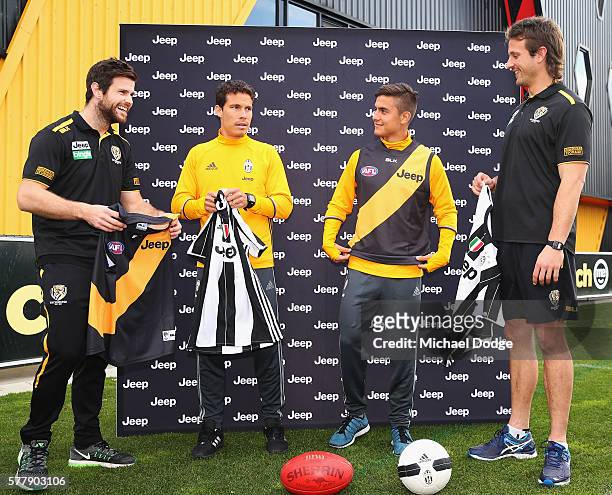 Trent Cotchin and Ivan Maric of the Tigers pose with Hernanes and Paulo Dybala of Juventus exchange guernseys during a Richmond Tigers AFL and...