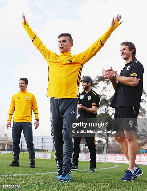 Trent Cotchin and Ivan Maric of the Tigers react with Hernanes as his teammate Paulo Dybala of Juventus celebrates kicking a goal during a Richmond...