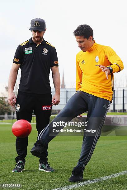 Trent Cotchin of the Tigers watches Hernanes of Juventus kick a ball during a Richmond Tigers AFL and Juventus FC media opportunity at Punt Road Oval...