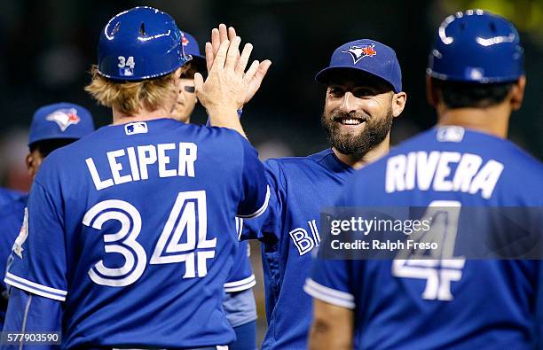 Kevin Pillar of the Toronto Blue Jays is congratulated by Tim Leiper and teammates after a 5-1 victory against the Arizona Diamondbacks during a MLB...