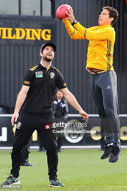 Trent Cotchin of the Tigers watches Hernanes of Juventus mark an AFL football during a Richmond Tigers AFL and Juventus FC media opportunity at Punt...