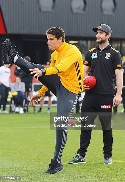 Trent Cotchin of the Tigers watches Hernanes of Juventus kick an AFL football during a Richmond Tigers AFL and Juventus FC media opportunity at Punt...