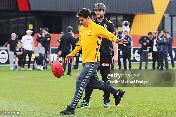 Trent Cotchin of the Tigers watches Hernanes of Juventus kick an AFL football during a Richmond Tigers AFL and Juventus FC media opportunity at Punt...