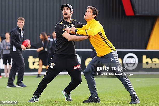 Trent Cotchin of the Tigers competes for an AFL football against Hernanes of Juventus during a Richmond Tigers AFL and Juventus FC media opportunity...