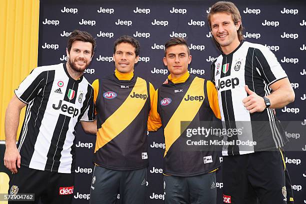 Trent Cotchin and Ivan Maric of the Tigers pose with Hernanes and Paulo Dybala of Juventus during a Richmond Tigers AFL and Juventus FC media...