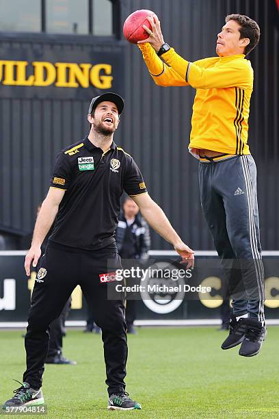 Trent Cotchin of the Tigers watches Hernanes of Juventus mark an AFL football during a Richmond Tigers AFL and Juventus FC media opportunity at Punt...