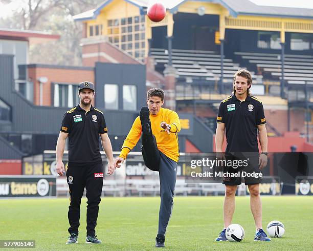 Trent Cotchin and Ivan Maric of the Tigers watch Hernanes of Juventus kick an AFL football during a Richmond Tigers AFL and Juventus FC media...