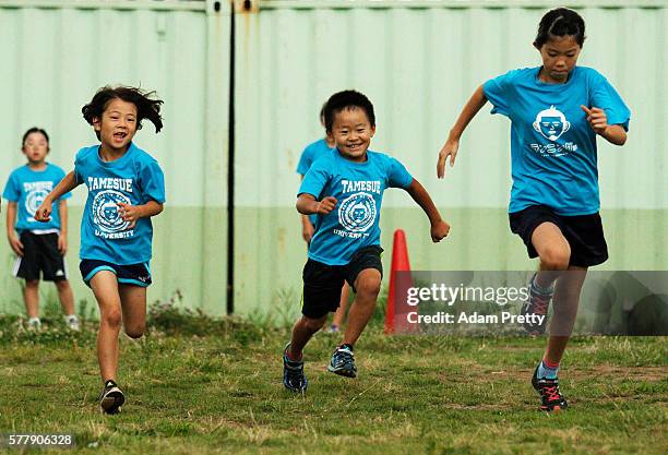 Children participate in the track and field class for children 'Tamesue University Running Club' at Toyosu MAGIC BEACH on July 14, 2016 in Tokyo,...