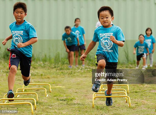 Children participate in the track and field class for children 'Tamesue University Running Club' at Toyosu MAGIC BEACH on July 14, 2016 in Tokyo,...