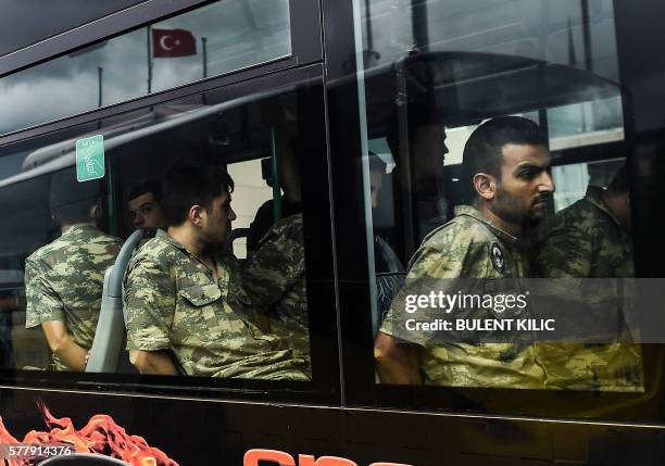 Detained Turkish soldiers who allegedly took part in a military coup arrive in a bus at the courthouse in Istanbul on July 20 following the military...