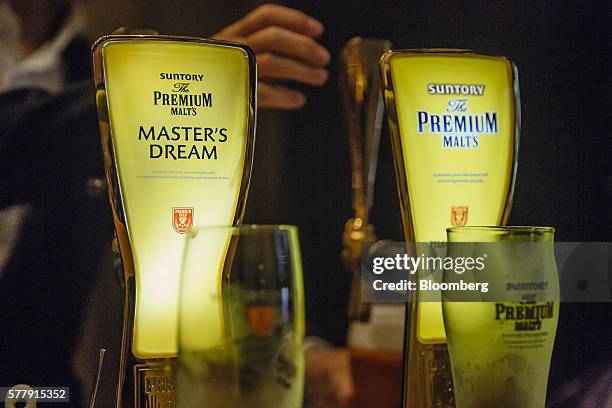 Taps of Suntory Holdings Ltd.'s The Premium Malt's Master's Dream, left, and Pilsner beer stand at the bar at the company's Master House bar in Hong...