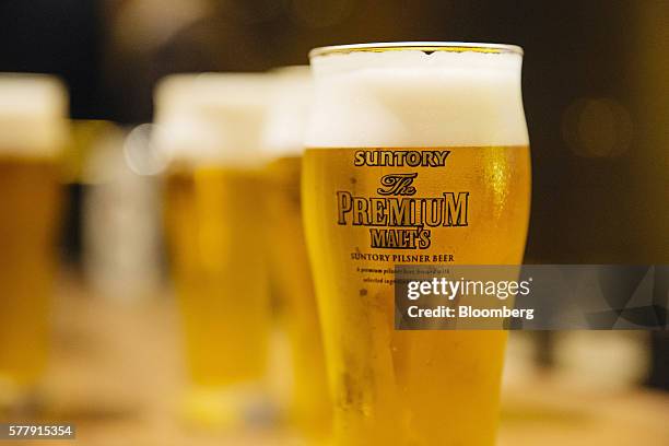 Glass of Suntory Holdings Ltd.'s The Premium Malt's Pilsner beer is arranged for a photograph at the company's Master House bar in Hong Kong, China,...