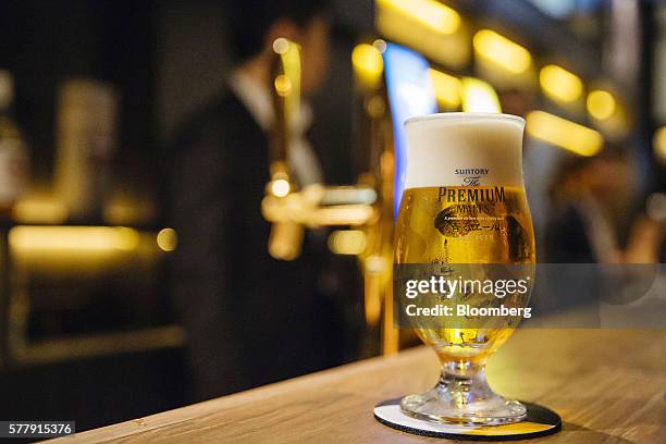 Glass of Suntory Holdings Ltd.'s The Premium Malt's Ale beer is arranged for a photograph at the company's Master House bar in Hong Kong, China, on...