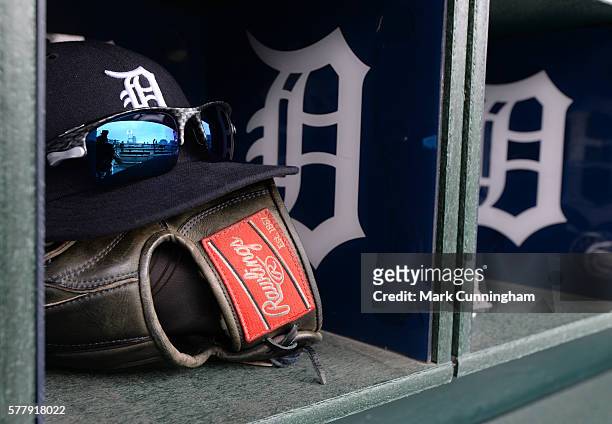 Detailed view of a Detroit Tigers baseball hat and Rawlings glove sitting in the dugout prior to the game against the Seattle Mariners at Comerica...